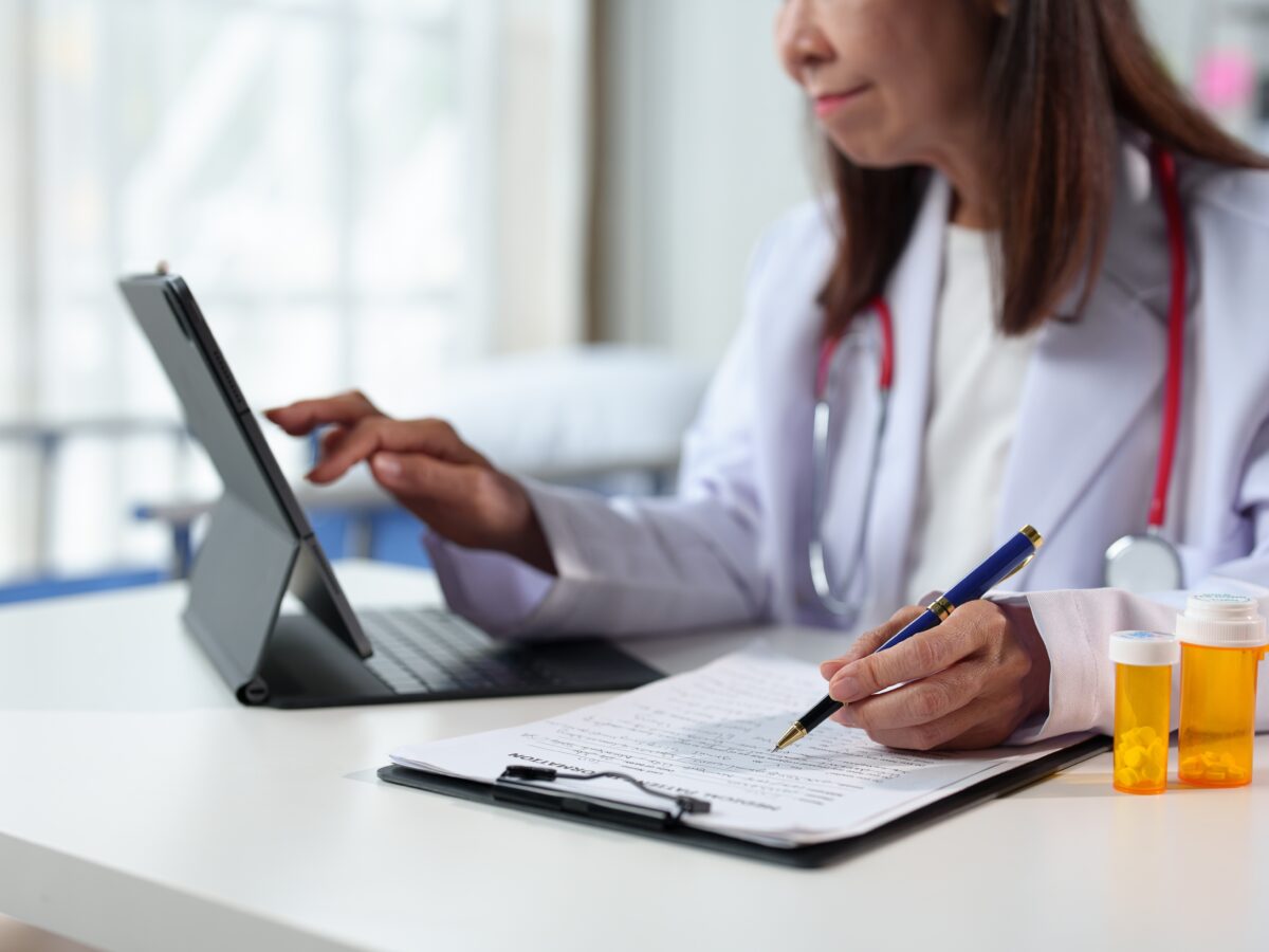 Young,Female,Doctor,Sitting,At,The,Desk,Preparing,To,Receive