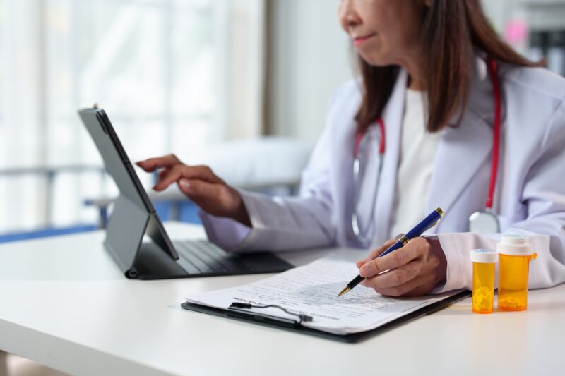 Young,Female,Doctor,Sitting,At,The,Desk,Preparing,To,Receive